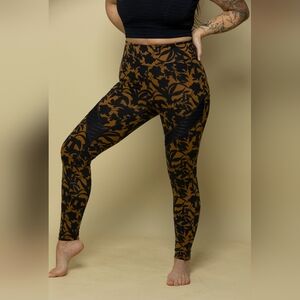 Womens High-waisted yoga leggings w black & mustard floral print mesh. Size L/XL
